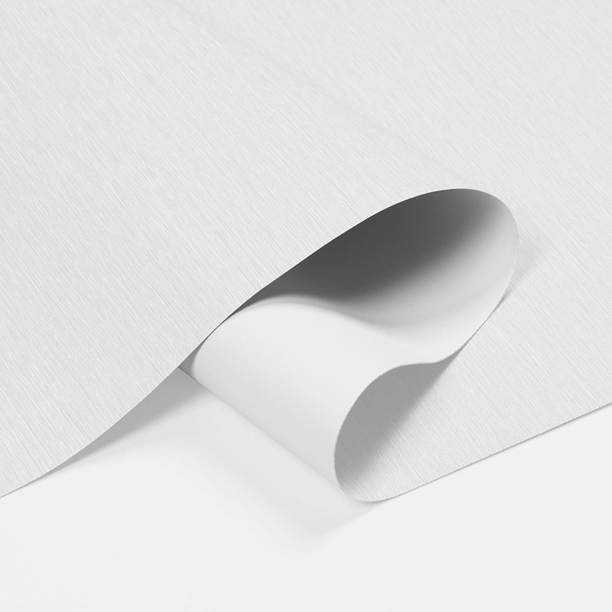 Close-up of white textured vinyl wallpaper sheet curling at edge on white surface