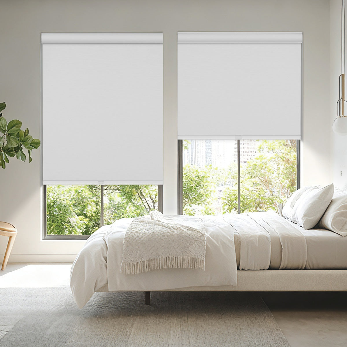 Modern bedroom with white roller blinds covering large windows and cozy neutral bedding