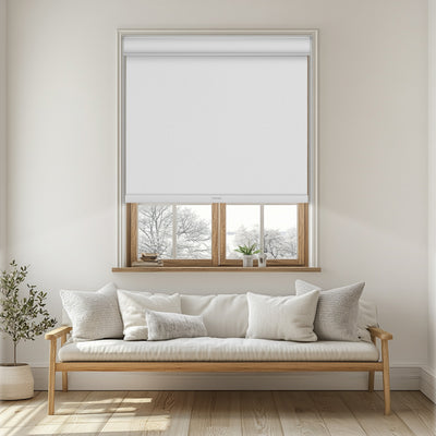 Sulugood Faux Linen Blackout Fabrics Cordless Roller Shades installed in a cozy living room window.