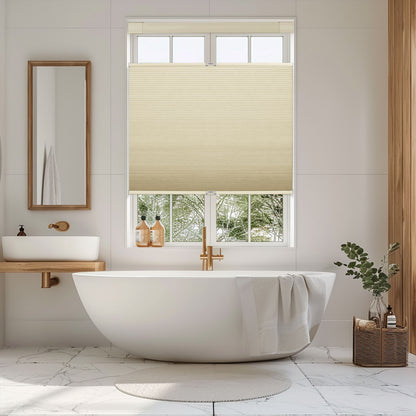 Modern bathroom with white freestanding tub, beige cellular window shade, and wooden accents