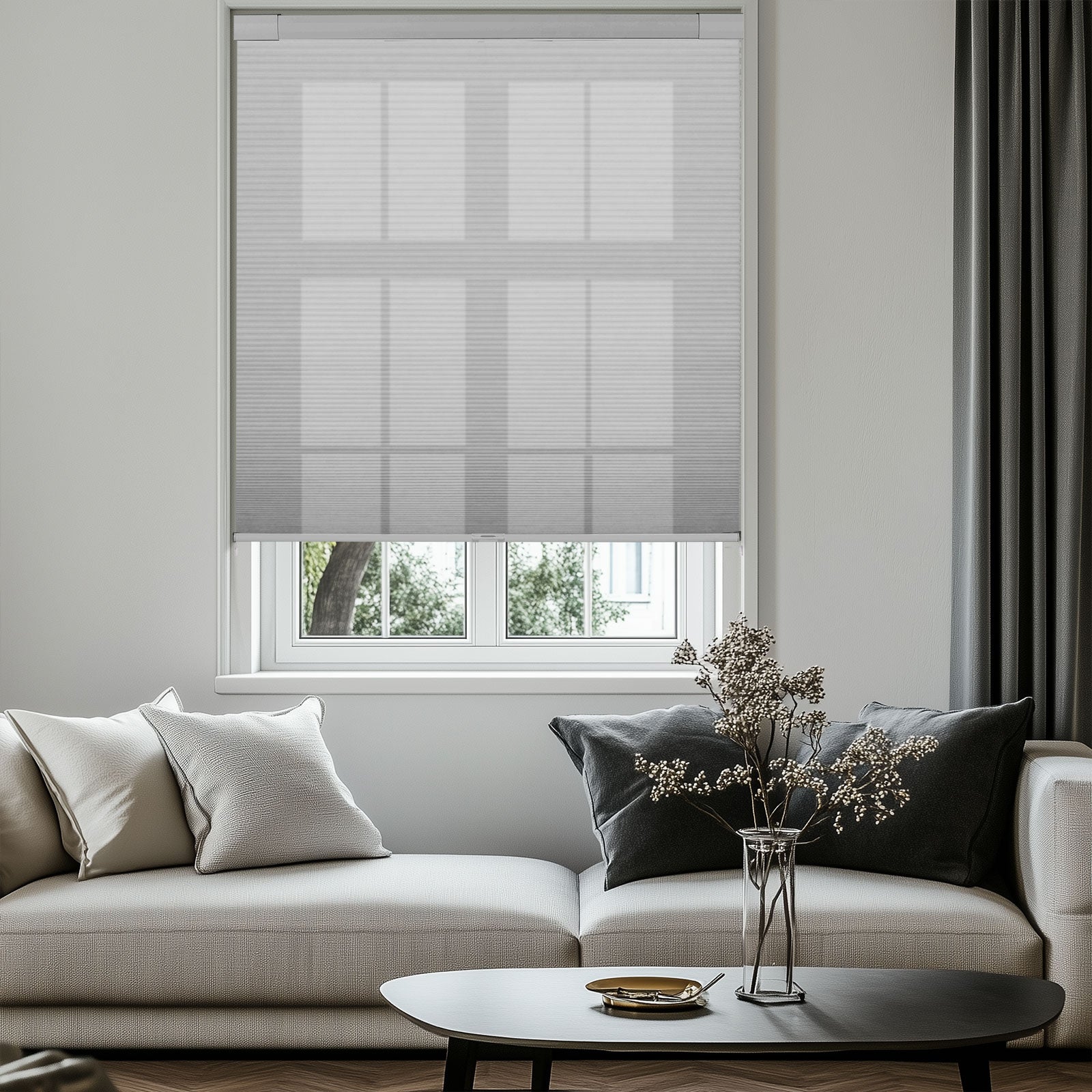 Modern living room with beige sofa, gray curtains, sheer blinds, and decorative vase on black coffee table