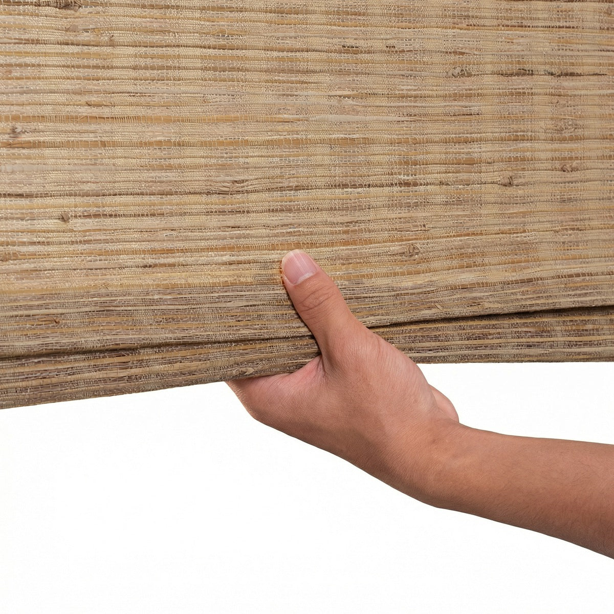 Sulugood Natural Cordless Light Filtering Bamboo Roman Shades held in hand, showcasing natural bamboo texture.