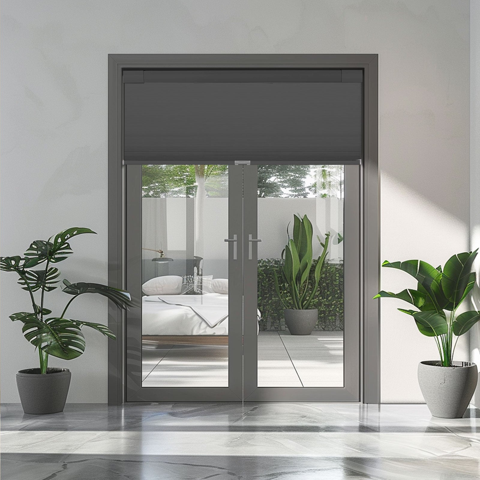Modern glass double doors with gray frame and roller blind, flanked by potted green plants
