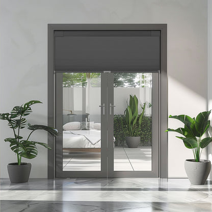 Modern glass double doors with gray frame and roller blind, flanked by potted green plants