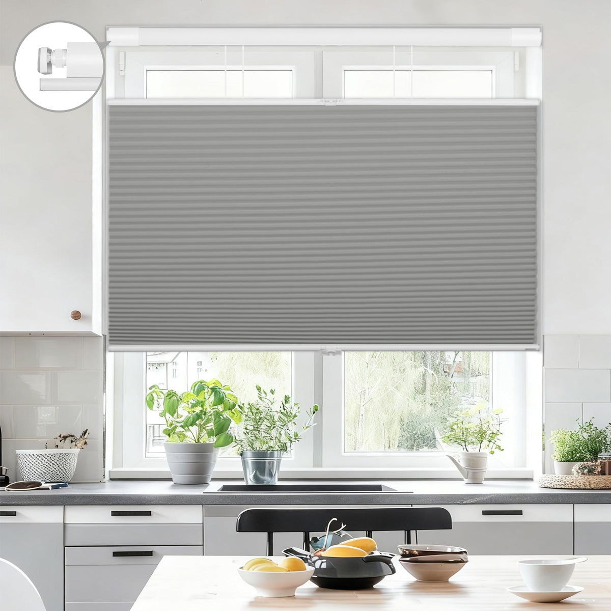 Modern kitchen window with gray cellular shades, countertop plants, and tableware in bright setting