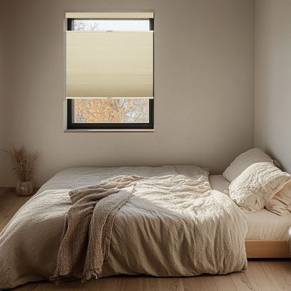 Minimalist bedroom with beige bedding, textured blanket, and half-covered window with beige blind