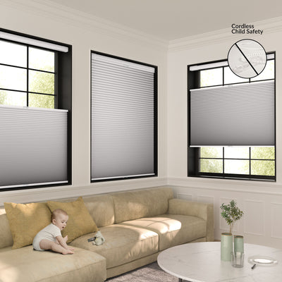 Living room with beige sectional sofa, cordless gray window blinds, baby on sofa, plant on round marble table