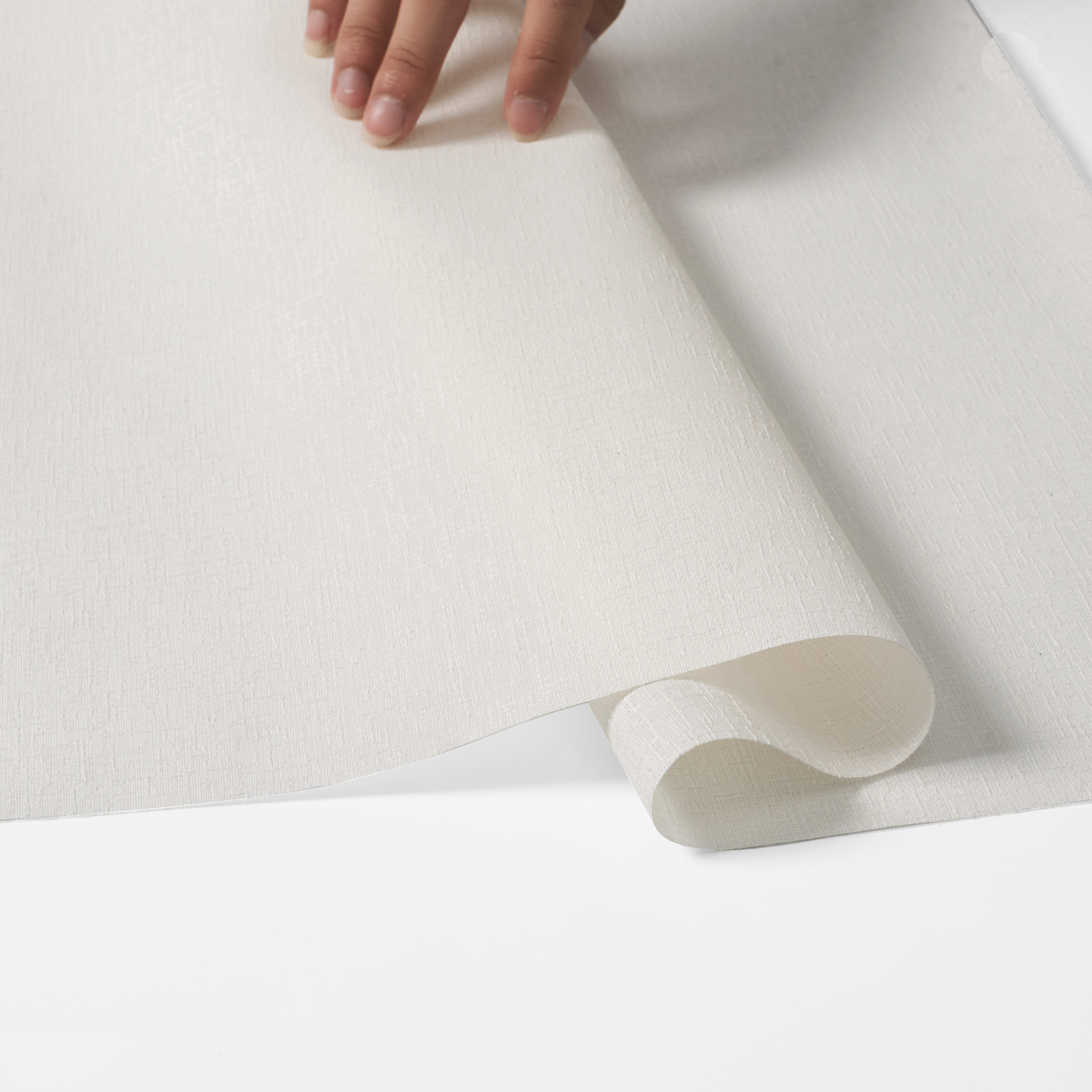 A close-up of a hand holding material for Sulugood Classic Cordless Roman Shades, showcasing its fabric texture.
