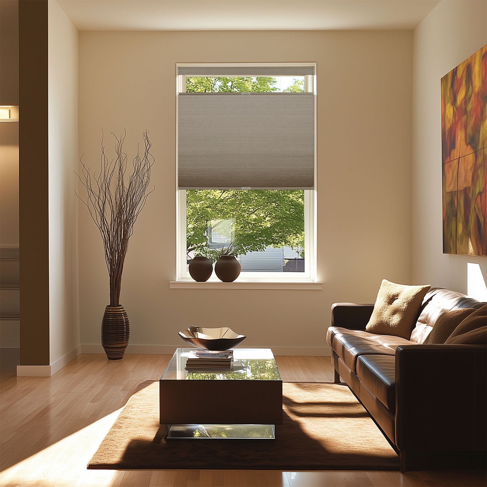 Modern living room with brown leather sofa, glass coffee table on rug, window with beige blinds, decorative vases